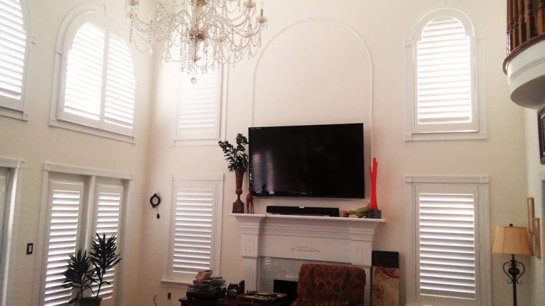 Austin great room with wall-mounted TV and high-ceiling windows.